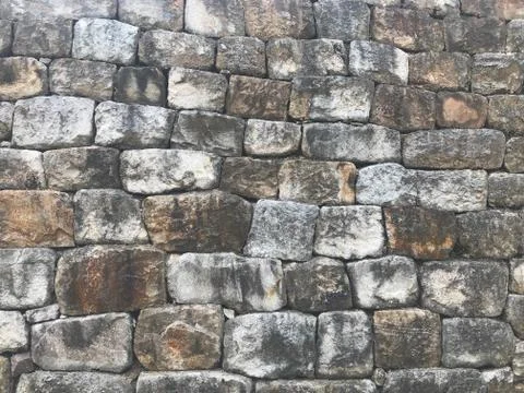 Grey stone wall as a background texture Stock Photos