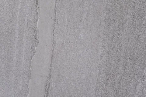 A grey stone wall with a crack in it Stock Photos