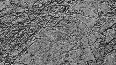 A grey stone wall with a rough texture. The wall is covered in small, jagged  Foto stock