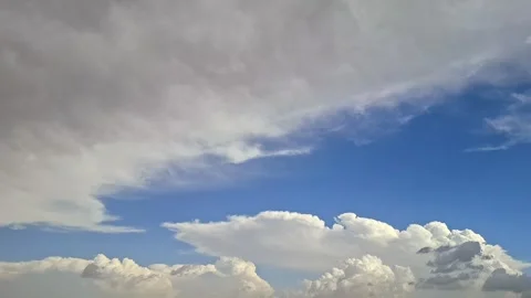 Grey Storm Clouds Merging With Deep Blue Sky Above White Cumulus Video stock 332994203