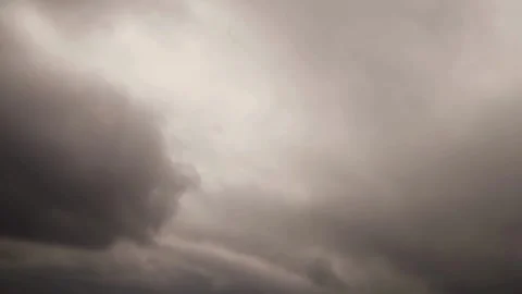 Grey storm clouds swirl in moody sky Stock Footage 329545643
