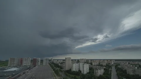 The grey stormy clouds streaming over the cityscape. time lapse 動画素材 133184257