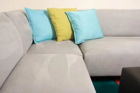 Grey Suede Couch &amp; Pillows Stock Photos