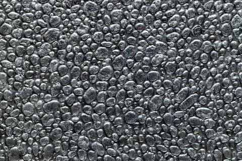 Grey texture background. Black styrofoam foam material or white plastic polys Stock Photos