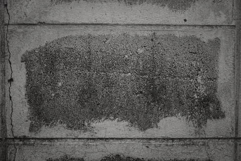 A grey wall with a large crack in it Stock Photos