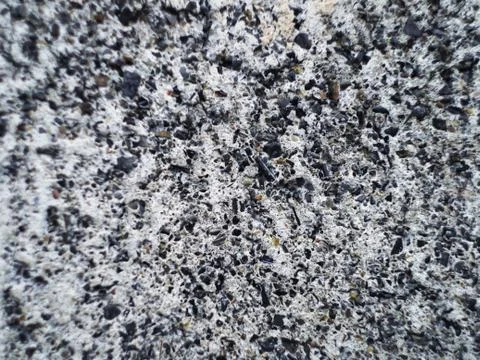 Grey wall made of marble aggregate with small crumbs, close up view. Foto stock