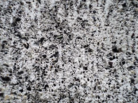 Grey wall made of marble aggregate with small crumbs, close up view. Stock Photos