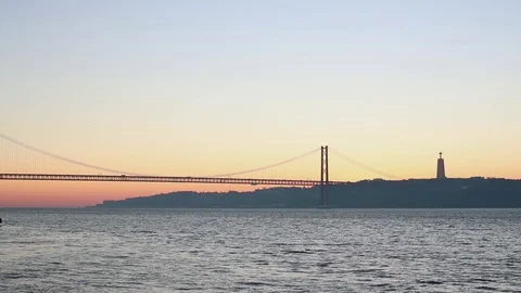 Grey water surface of a wide river at dawn against the backdrop of a bridge Stock Footage 130116869