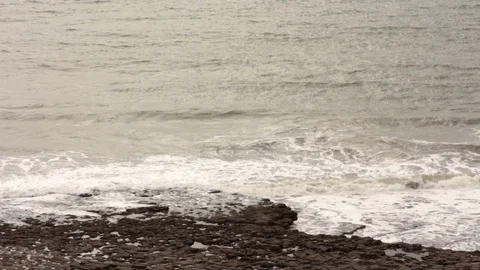 Grey Waves Overlap Each Other at a Stony Beach Video stock 93169267