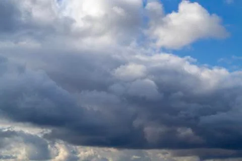Grey white clouds. Thunderclouds clouds on blue sky. Spring day. Beautiful na Stock Photos