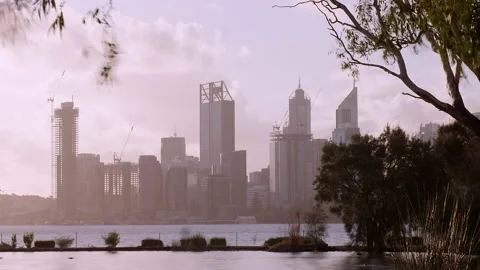 Grey winter clouds shoot across city skyline - river, pond, ducks in foreground Stock Footage 196140298