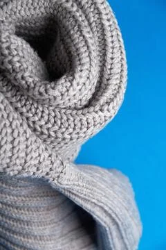 Grey wool scarf on a blue background.selective focus Stock Photos