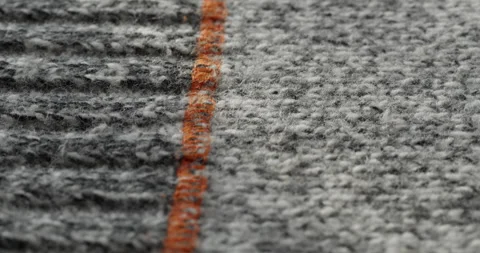 Grey woolen fabric close-up. Macro shooting of soft and warm knitted cloth Stock Footage 167901808