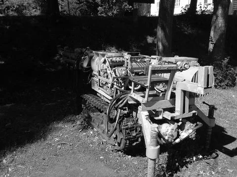 Greyscaled image - Old yellow machine used for mining coal, partly hidden in Stock Photos