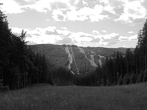 Greyscaled image - panoramic long distance view on ski slope in summer | Stock Photos