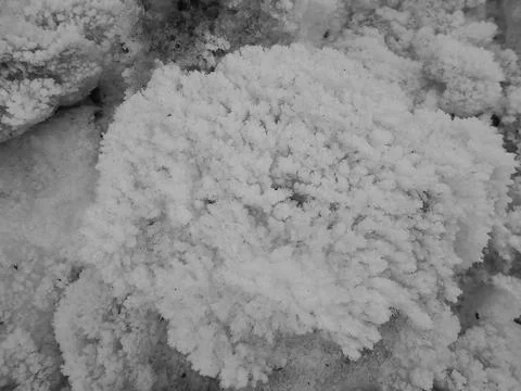 Greyscaled image - Snow boulder with ice crystal structure on the surface. Stock Photos