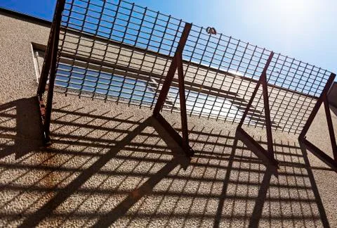 Grid balcony that throws shadows Stock Photos