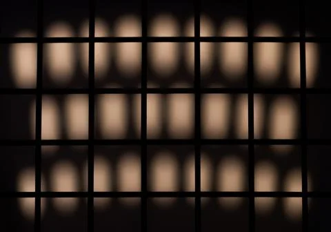Grid cast a shadow on a lit wall Stock Photos