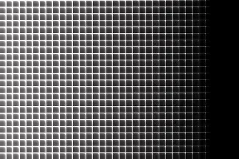 Grid of glowing rounded squares fading to black on right side rounded Stock Illustration