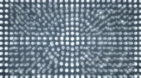 Grid of light bulbs lighting up bright white Stock Footage 331457516