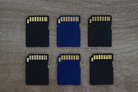 Grid of micro SD memory cards on wooden surface Stock Photos