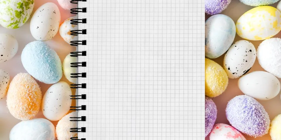 A grid-patterned notebook page is open, spiraled on the left, surrounded by colo Stock Photos