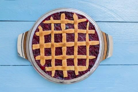 Grid rustic cake with forest berries on blue wood Stock Photos