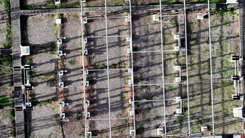 Grid shadows stretch across solar panels below Stockbeeldmateriaal 344803664