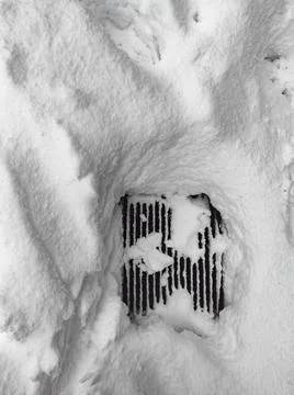 Grid surrounded by snow Stock Photos