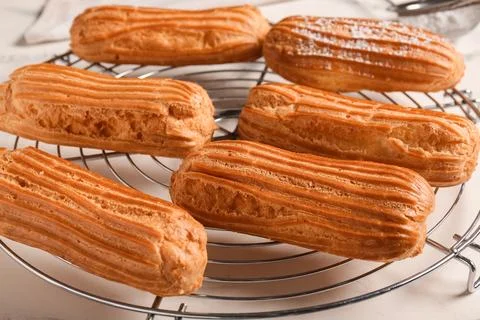 Grid with tasty eclairs on marble background Stock Photos
