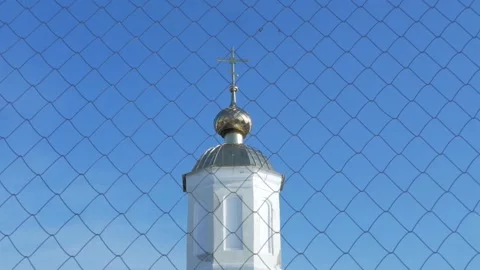 Grid through which the gold dome of the church with cross can be seen in the Video stock 147846038