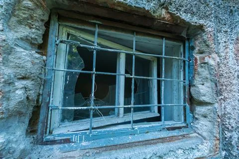 Grid on window of abandoned building Stock Photos