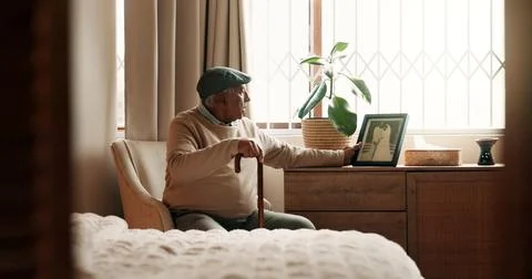 Grief, frame or old man in bedroom with walking stick, mourning or memory o.. Stock Photos
