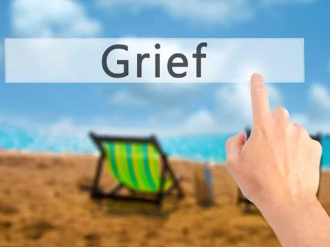 Grief - Hand pressing a button on blurred background concept on visual screen Fotos de archivo