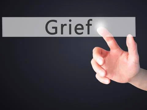 Grief - Hand pressing a button on blurred background concept on visual screen Fotos de archivo