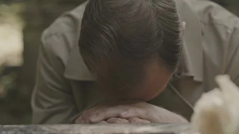 Grieving Man Mourns Deeply Beside Loved Ones Gravestone Stock Footage 321036370