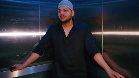 Grieving man stands in elevator with emotional agony Stock Footage 310285032