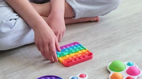 Gril presses bubbles on morden silicone toy pop it. Anti stress sensory toys Stock Footage 158190254