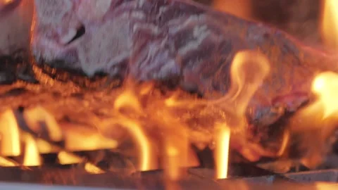 Grill and flip the tomahawk steak, on a gas grill with fire Stock Footage 160606987