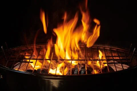 Grill Background. Barbecue Fire Grill close-up, isolated on Black Background Stock Photos