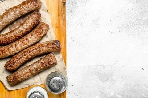 Grill beef sausages on a wooden Board . Stock Photos