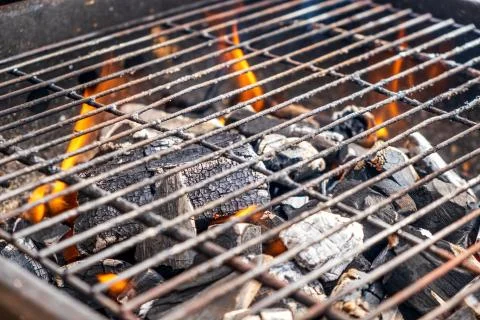 Grill charcoal burning with an open flame isolated Stock Photos