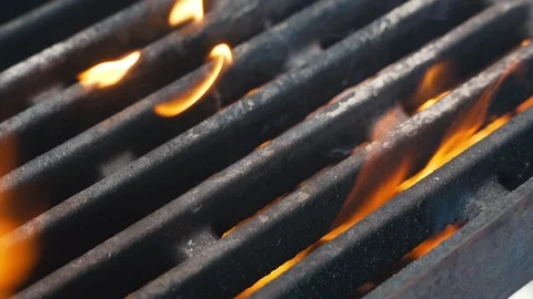 Grill in the kitchen of the restaurant, flame seeps through the grill 動画素材 107768272