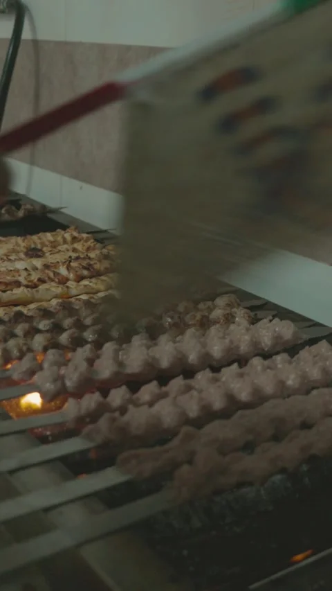 Grill master fanning flames, meat skewers on fire Video stock 305794645