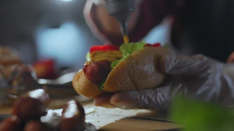 Grill. The master of hot snacks uses new recipe for preparing hot dog with y Stock Footage 271146193