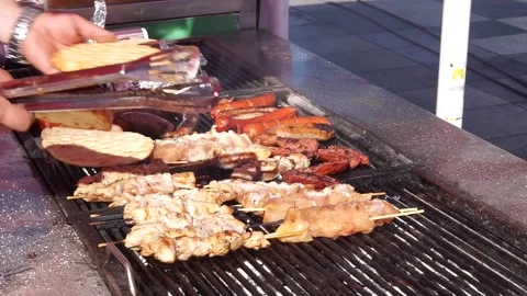 Grill master lays pita bread on fire grill in Green Fest Stock Footage 256605710