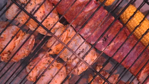 A grill with meat and corn on it Stock Footage 276343981