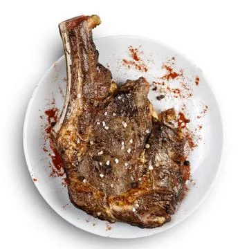 Grill the meat with a bone on a white plate. Isolated. Stock Photos