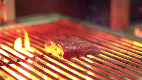 Grill meat on grill hard fire handheld slow motion Video stock 156250287