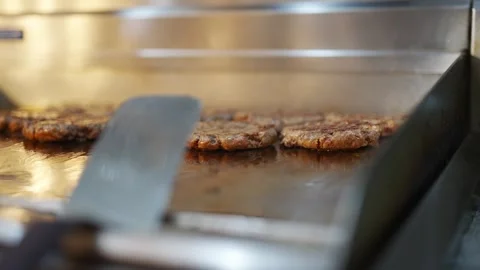 A grill with meat on it and a spatula Stock Footage 296055895